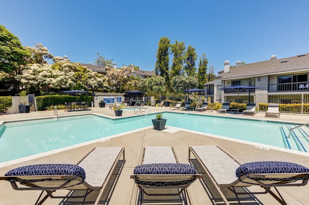 our apartments offer a swimming pool with tables and chairs at Harbor Pointe, California, 92629