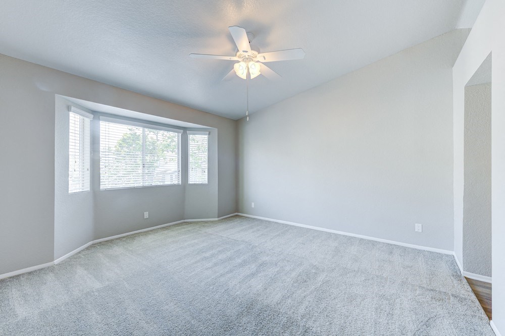 an empty living room with a ceiling fan and a window at Harbor Pointe, California, 92629