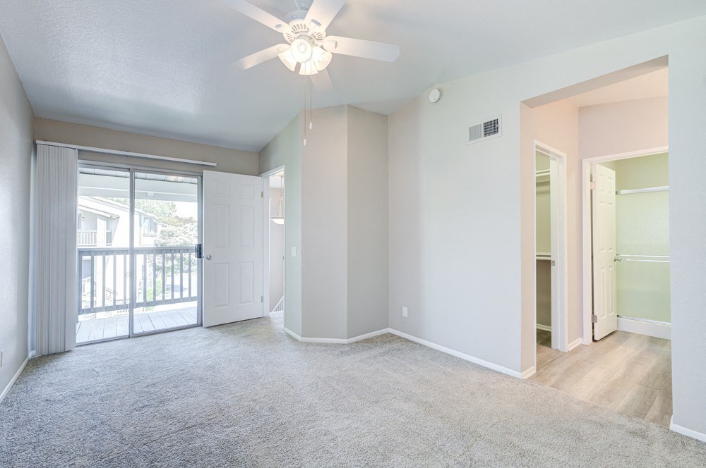 an empty living room with a ceiling fan and a door to a balcony at Harbor Pointe, Dana Point, CA, 92629