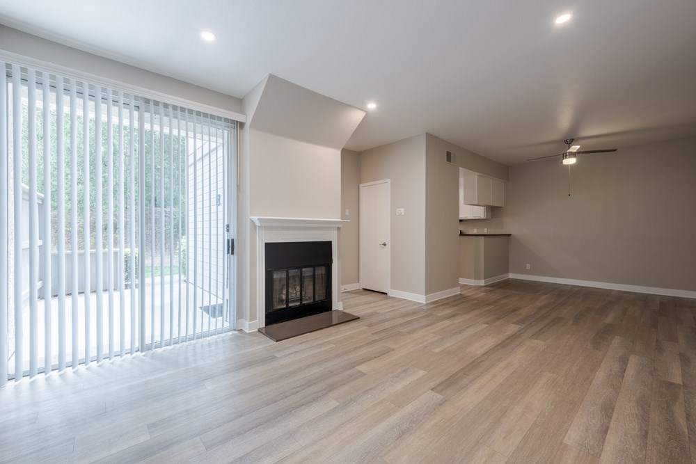 A room with a fireplace and wooden floors. at Harbor Pointe, Dana Point, California