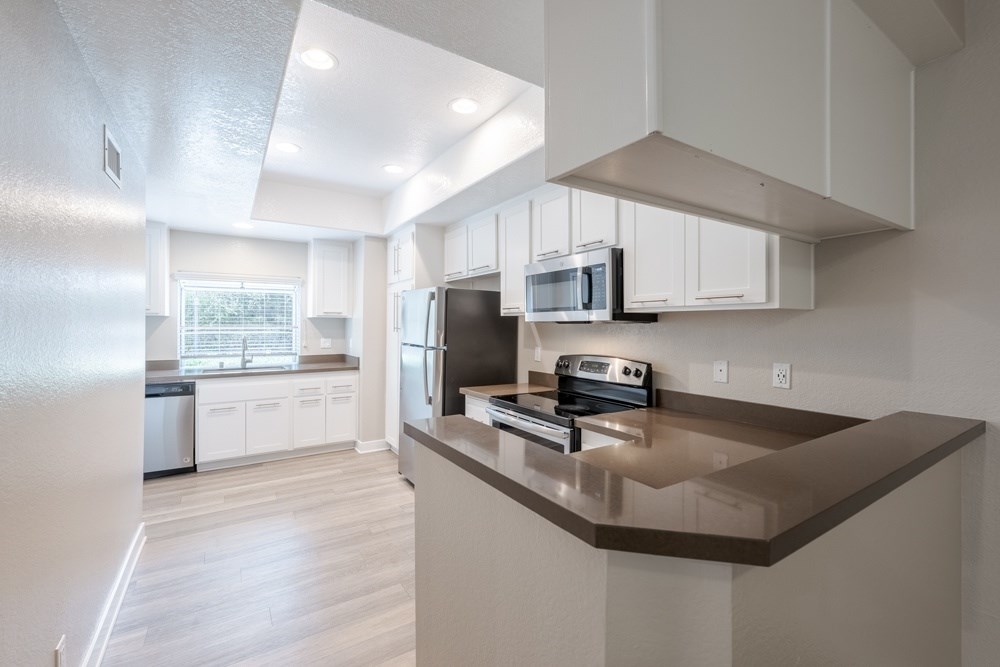 A modern kitchen with a refrigerator, microwave, and oven. at Harbor Pointe, Dana Point, 92629