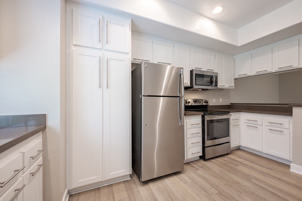 A kitchen with a stainless steel refrigerator, microwave, and oven. at Harbor Pointe, Dana Point