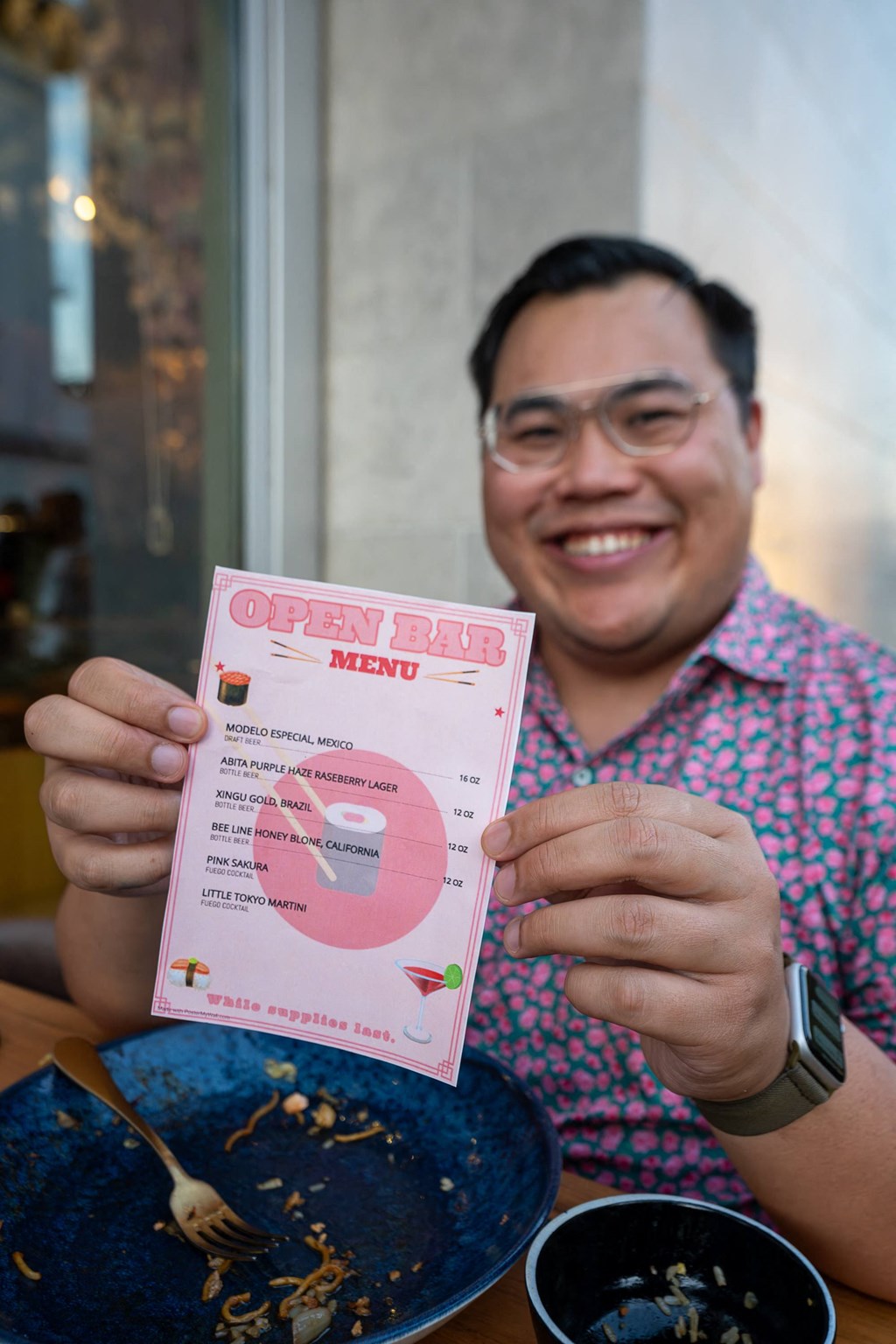 Man holding pink menu card.