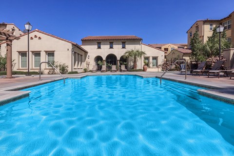 a swimming pool with a building in the background