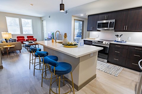 furnished kitchen with stool seating at Bayswater Apartments, California