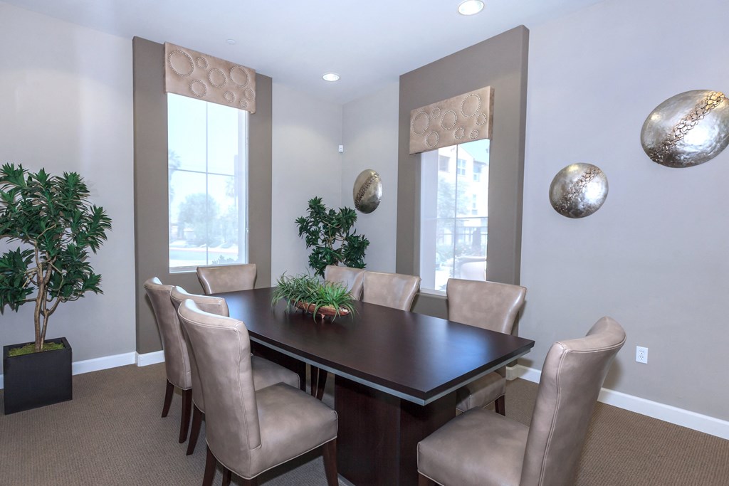 a dining room with a table and chairs and a window