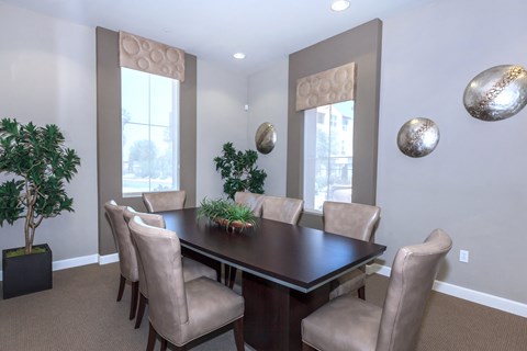 a dining room with a table and chairs and a window