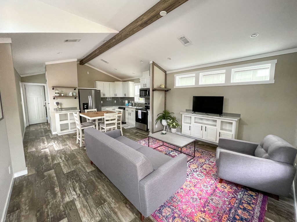 casata model with a living room with couches a coffee table and a tv