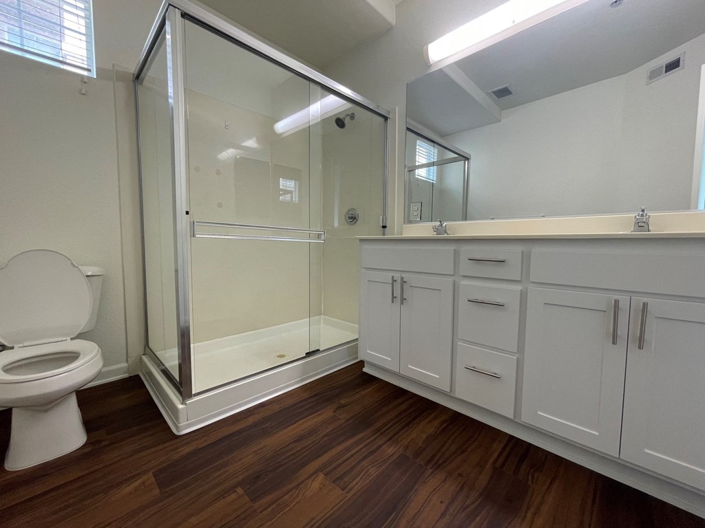 unfurnished bathroom with updated white cabinetry