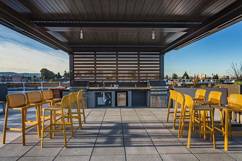Rooftop Grill Area With Wood-Style Seating, City Views, And Gazebo-Style Covering. at Bayswater Apartments, Burlingame, CA