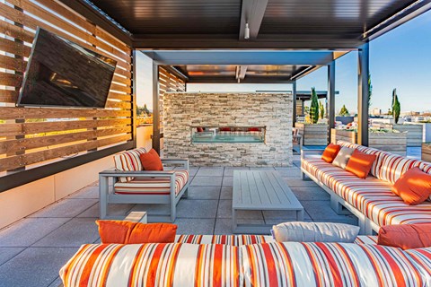 Rooftop lounge seating with TV and fireplace at Bayswater Apartments, California