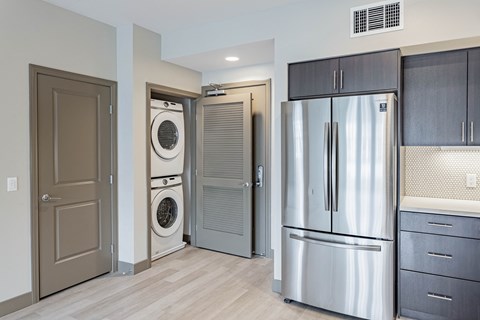 Stainless steel fridge and in unit washer and dryer at Bayswater Apartments, Burlingame, CA