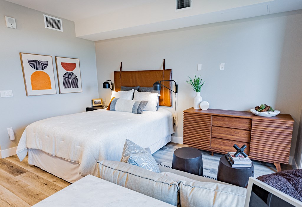 1 & 2 BR Apartments In Sunnyvale, CA - 1250 Lakeside - Well Lit Bedroom With Wood-Style Flooring, Modern Decor, Oversized Windows, And Queen Bed