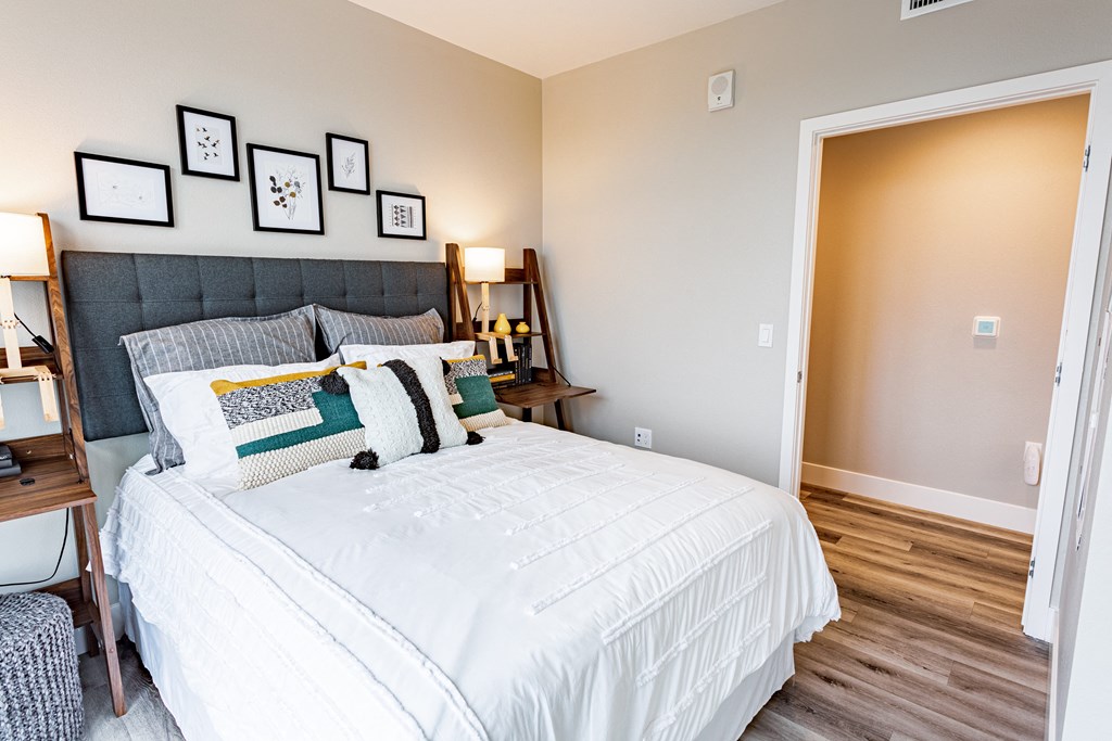 Bed with throw pillows, artwork on the walls.