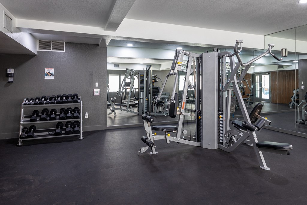 A gym with a variety of equipment including weights and machines at Verandas Apartments, West Covina, CA, 91791