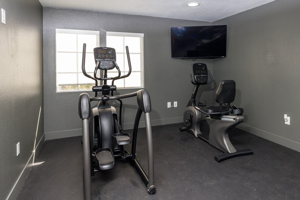 A home gym with a stationary bike and a treadmill at Verandas Apartments, West Covina