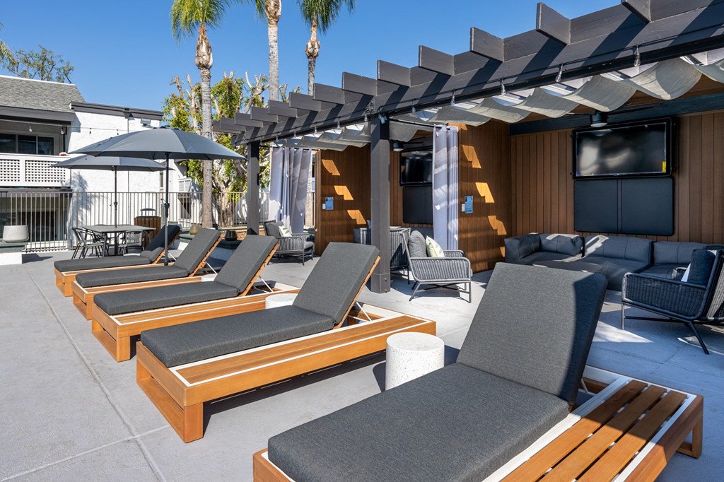 A patio with wooden furniture at Verandas Apartments, West Covina