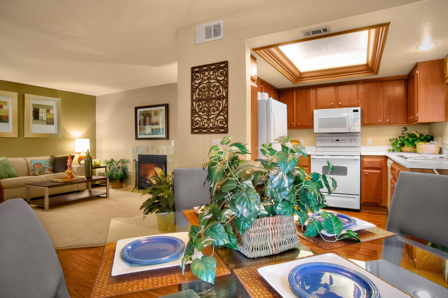 a living room and kitchen with a table and chairs
