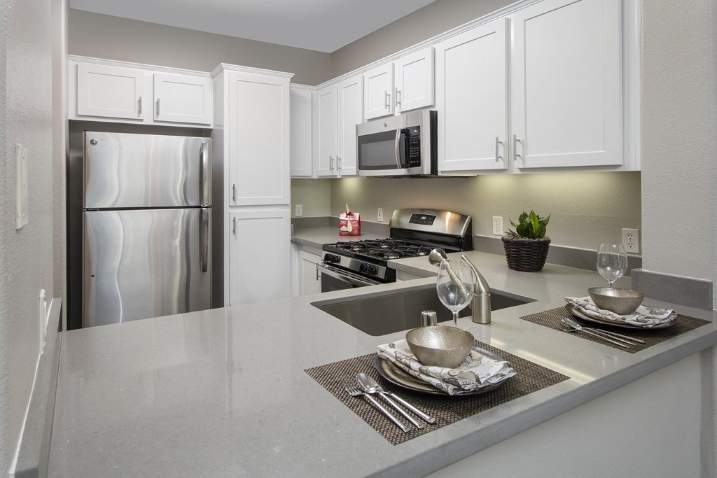 Kitchen with Stainless Steel Appliances, High Ceilings, and Large Cabinet Space at 55+ Remington at Ladera Ranch, California