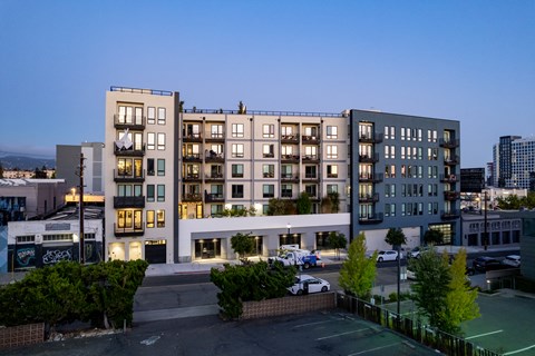 an aerial view of an apartment building in the city at dusk
