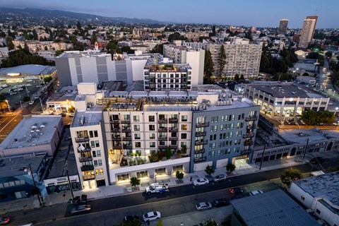 an aerial view of an urban cityscape at night with tall buildings