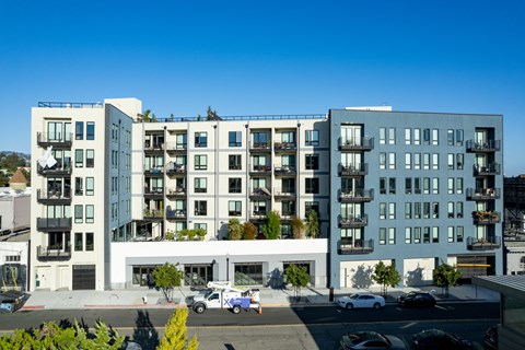 an aerial view of an apartment building on a city street