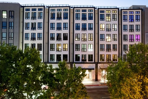 the facade of a building with trees in front of it