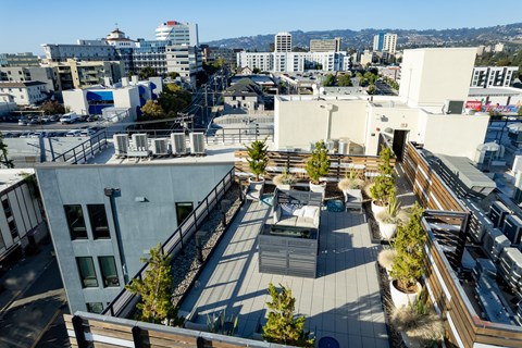 a roof terrace with a city in the background