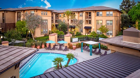 A large apartment complex with a pool and patio area.