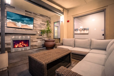 A modern living room with a fireplace and a flat screen TV.