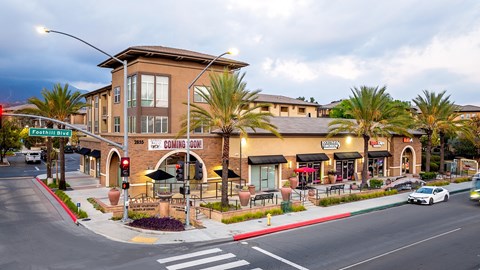 A street view of a building with a sign that says "Coming Soon".