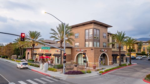 A street view of a building with a red traffic light.
