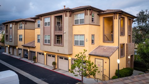 Apartment building with a white car parked in front.