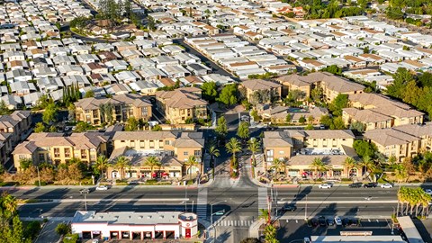 A large aerial view of a residential area with houses and a shopping center.