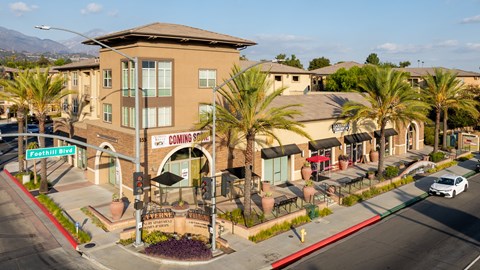 A street view of a building with a sign that says "Coming Soon".