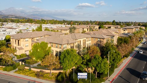 A large, well-maintained residential complex with a clear sky above.