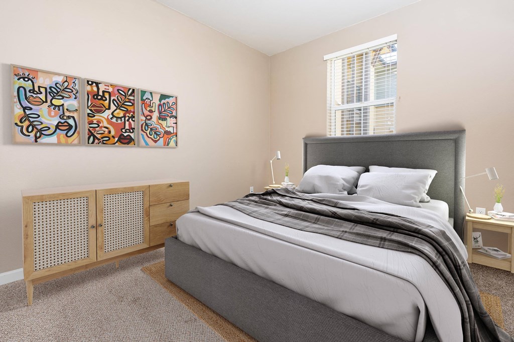 a bedroom with a bed and two windows