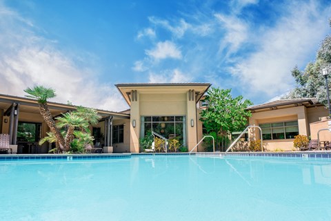 a swimming pool with a building in the background