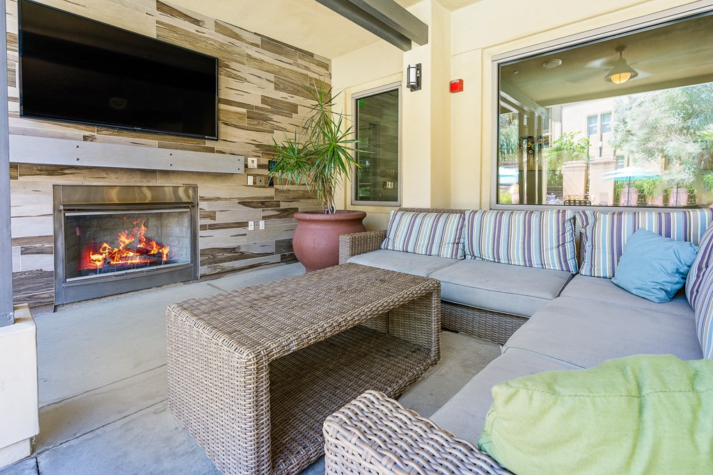 a living room with a couch and a coffee table in front of a fireplace