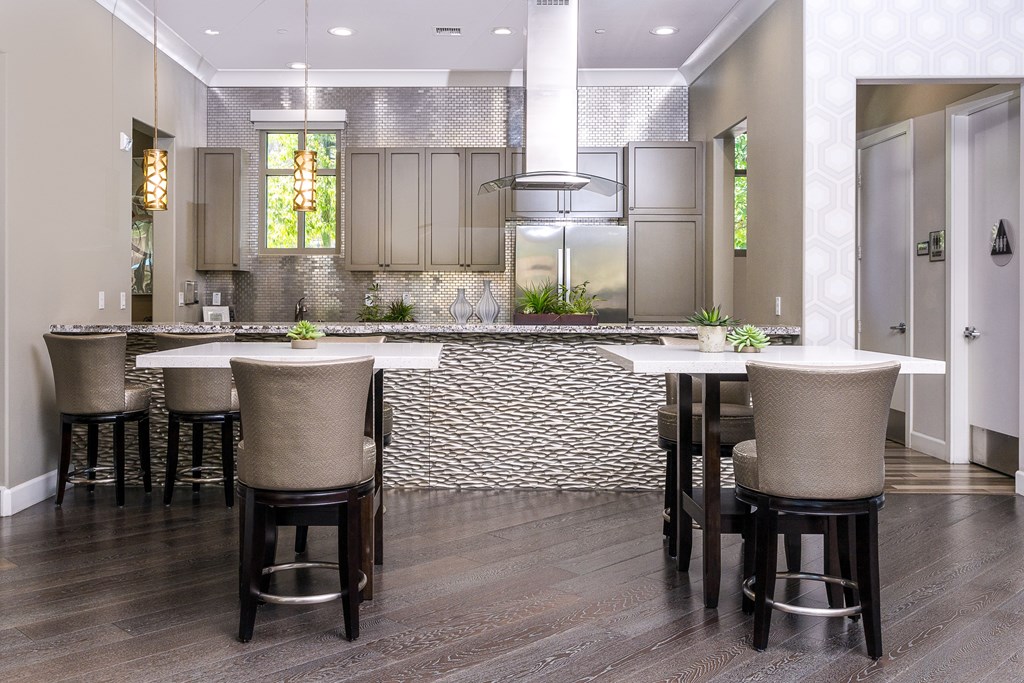 a kitchen with a large center island with a white countertop