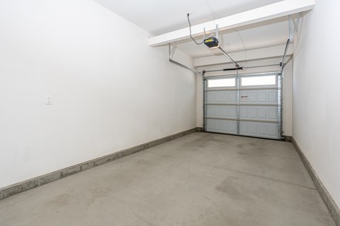 a large empty room with a garage door