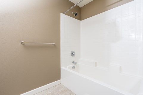 a bathroom with a tub and shower
