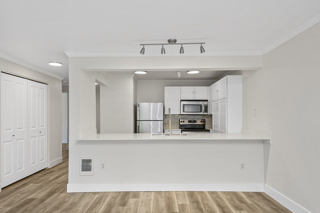 a kitchen with white cabinets and a white counter top