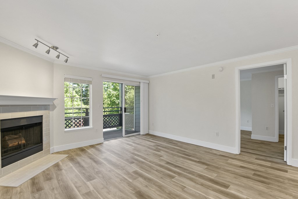 a living room with wood style flooring and sliding glass doors with a window.