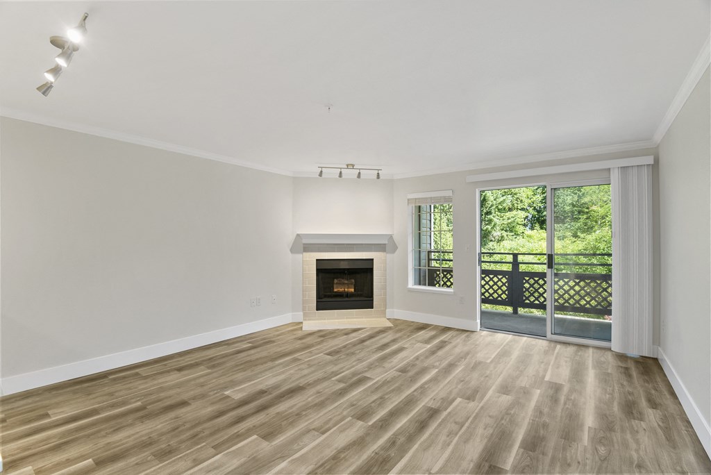 a living room with a fireplace and a balcony