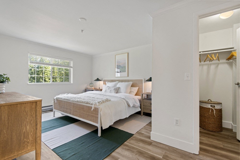 a bedroom with a bed and a dresser and a mirror at Lakemont Orchard, Issaquah