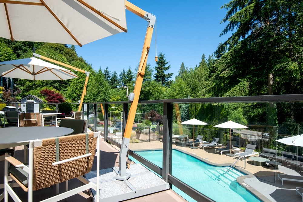 a view of a swimming pool from a patio with tables and chairs at Lakemont Orchard, Issaquah Washington
