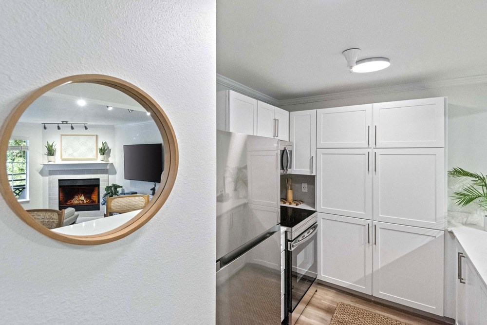 a mirror and a white kitchen with a fireplace at Lakemont Orchard, Issaquah, 98027