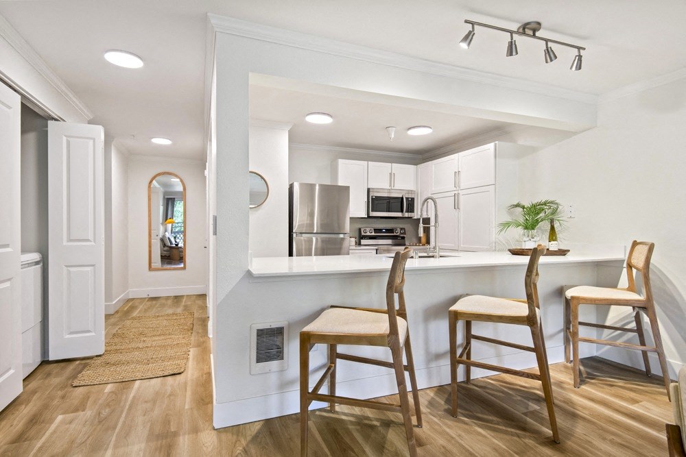 a kitchen with a bar and stools in a house at Lakemont Orchard, Washington, 98027