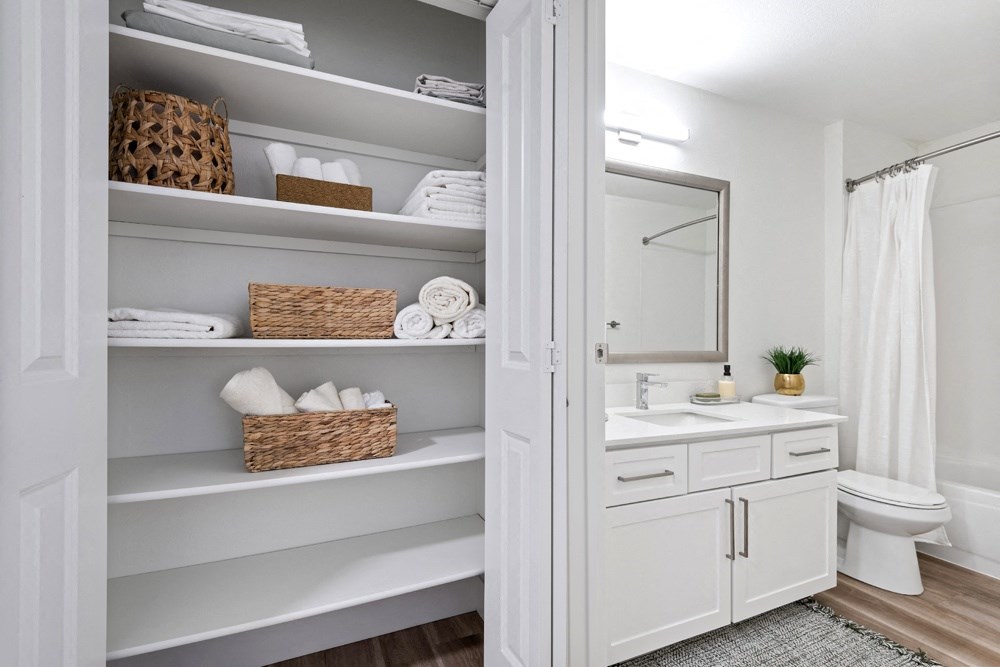 a white bathroom with open shelving and a white toilet and sink at Lakemont Orchard, Issaquah Washington